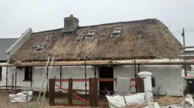 Thatched Cottage stripped of the old thatch. Getting prepared to add on a new coat of water reed.
