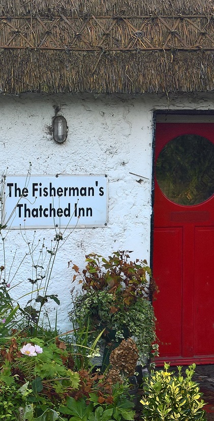 Thatched pub sign and door. Inviting you in.